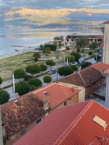 a view of a town with red roofs and a body of water at One Bedroom Apartment Lake View Pogradec in Pogradec