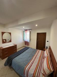 a bedroom with a bed and a dresser and a mirror at NidoPorcari in Porcari