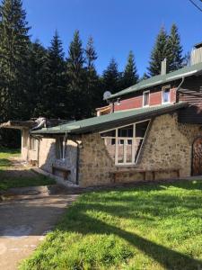 a stone house with a green roof at Hotel Chateau in Bukovel