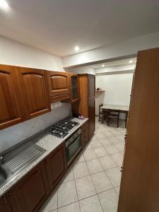 a kitchen with wooden cabinets and a stove top oven at NidoPorcari in Porcari