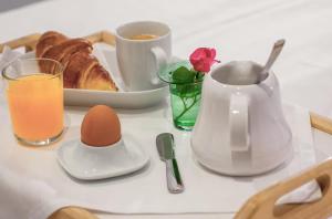 a table with a tray of breakfast foods and a glass of orange juice at Casa Branga in Deva