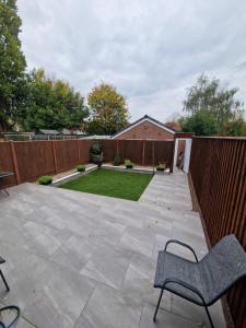 a garden with a patio and a fence at Sheldon Apartments BHX HS2 JLR NEC in Birmingham