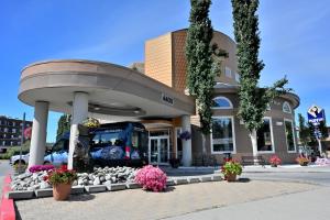 a bus stop with a bus in front of a building at Puffin Inn in Anchorage
