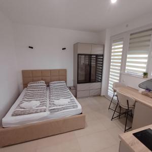 a bedroom with a bed with two ducks on the sheets at Apartman Nikol in Kumanovo +8 photos