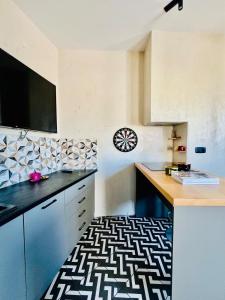 a kitchen with a black and white patterned floor at #ALS-On Air Luxury Rooftop in Mesochórion