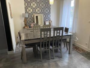 a dining room table with chairs and a mirror at Maison individuelle avec Jardinet in Arques-la-Bataille