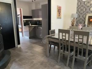 a kitchen and dining room with a table and chairs at Maison individuelle avec Jardinet in Arques-la-Bataille