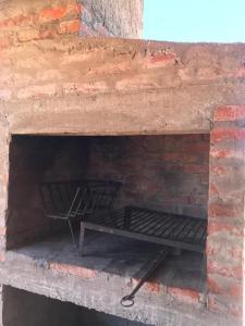a brick oven with a metal rack in it at Santo Descanso in Punta Del Diablo