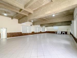 a large empty room with a white floor and wooden ceilings at Hotel Santiago in Lindóia +111 photos