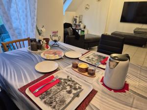 a table with a plate of food on top of it at Chez Ninie in Le Cloître-Saint-Thégonnec +18 photos