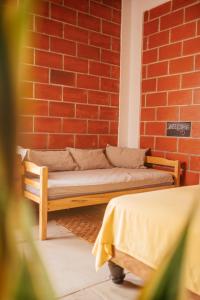 a couch in front of a brick wall at Free Spirit Ecuador, Puerto Engabao in Engabao