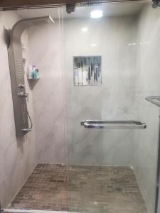 a shower with a glass door in a bathroom at Cozy Comfort in Brampton