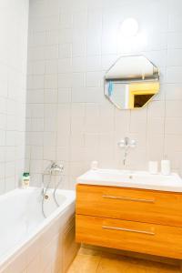 a bathroom with a bath tub and a sink at Apartmán 13 in Otilia
