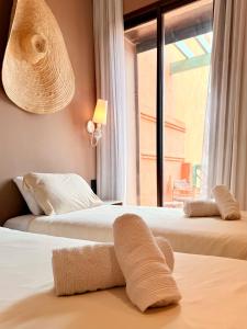 マラケシュにあるModern - Moroccan 2BR with Panoramic Pool Viewのホテルルーム内のベッド2台 ベッド上のタオル付 +15枚の写真