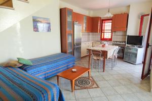a kitchen with a couch and a table in a room at Villetta indipendente a due passi dal mare  +14 photos