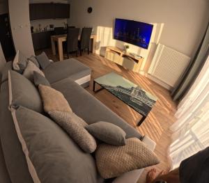a living room with a couch with pillows on it at Seapart Nowe Pogórze in Pogórze