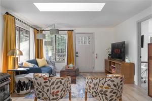 a living room with a blue couch and chairs at The Harold, Forested retreat with firepit in Hoodsport +33 photos