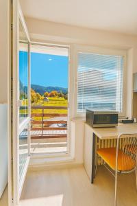 a room with a desk and a window with a view at Apartmán 12 in Otilia