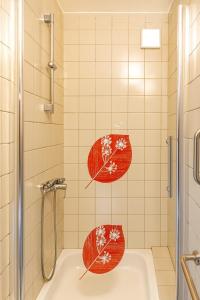 two umbrellas sitting on a tub in a bathroom at Apartmán 12 in Otilia