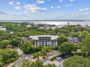 an aerial view of a building with trees and a lake at 891 Ketch Court in Hilton Head Island