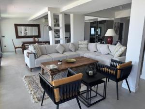 a living room with a couch and a table and chairs at Urla Villa in Urla