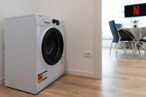 a white washing machine in a room with a table at Abano Terme-Luxury Suites, 4 ospiti-free parking in Abano Terme