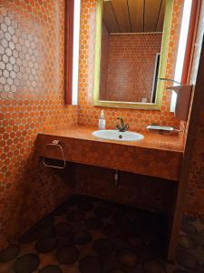a bathroom with a sink and a mirror at Privatzimmer -Venus- mit gemeinsamer Küche und Bad in der Altstadt Chur in Chur +2 photos