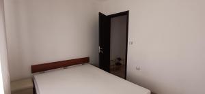 a bedroom with a bed and an open door at Апартаменти Борови хълмове in Pamporovo