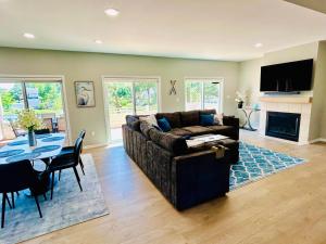 a living room with a couch and a table at Piney Point Harbor Haven in Piney Point