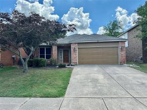 a brick house with a garage in a yard at Spacious Roanoke Retreat in Roanoke