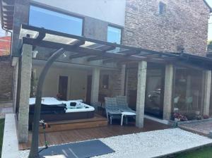 a wooden pergola with a bed on a patio at 7 Seconds in Sliema