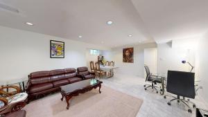 a living room with a leather couch and a table at Home Away From Home in Richmond Hill