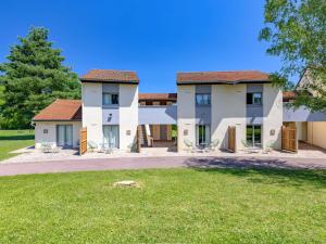a large building with a green lawn in front of it at Mercure Lyon Est Villefontaine in Villefontaine