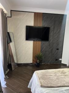 a bedroom with a flat screen tv on a wall at Brisa de Mar in Boca Chica +2 photos