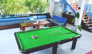 a living room with a pool table and a couch at Surf Dine in Matara