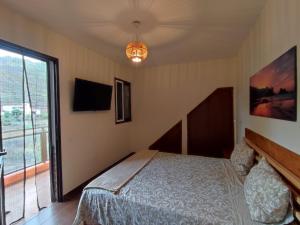 Un dormitorio con una cama y una ventana grande. en Casa Los Artesanos, en Santa Cruz de Tenerife