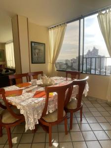 a dining room with a table and chairs and a window at Apartamento Casamar in Gaira +14 photos