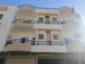 a building with balconies on the side of it at Guest room science in Marsa Alam City