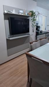 a living room with a flat screen tv on a wall at Casa 5 estrelas in Cascavel +29 photos