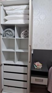 a closet with white shelves and a bunk bed at Casa 5 estrelas in Cascavel +30 photos