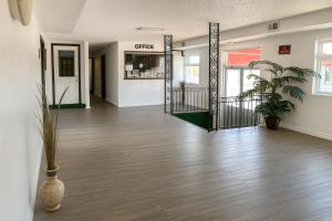 an empty room with a lobby with aoyer with plants at Economy Inn in Temple