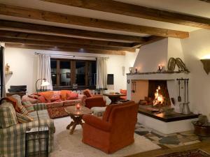 a living room with couches and a fireplace at Flow In in Kitzbühel
