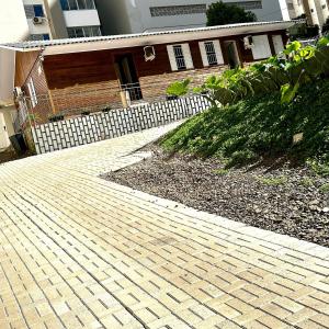 a brick driveway in front of a house at Loft Lux 3 (Smart TV, Ar condicionado, Cozinha...) in Chapecó +4 photos