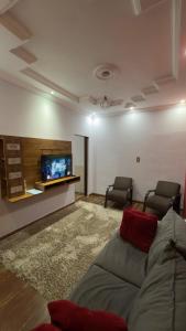 a living room with a couch and a flat screen tv at Refúgio real in Ouro Preto