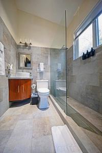 a bathroom with a toilet and a sink and a shower at Modern 4 Bedroom Infinity Pool Beach, Sunset, in Playa Hermosa +14 photos