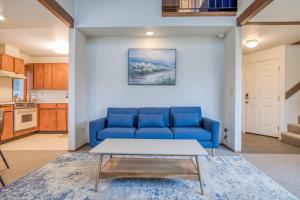 a blue couch in a living room with a table at Sea Base in Lincoln City