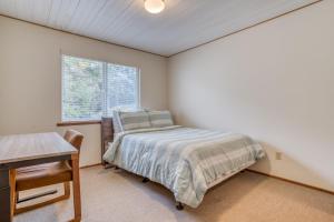 a bedroom with a bed and a desk and a window at Sea Base in Lincoln City +33 photos
