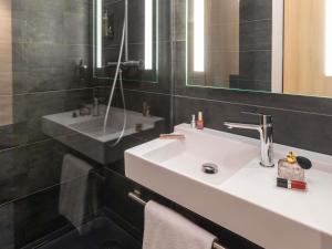 a bathroom with a white sink and a mirror at ibis Nancy Centre Stanislas in Nancy +36 photos