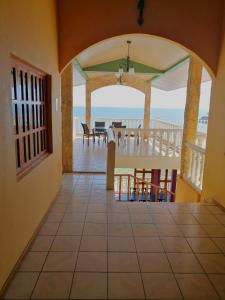 a room with a view of the ocean from a house at Hotel Rancho Infinito in El Cuco