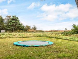 a small pond in the middle of a field at 5 person holiday home in Rømø in Kongsmark +21 photos